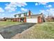 Charming two-story home with a spacious driveway and attached two-car garage with brick accent at 5549 Hollister Dr, Indianapolis, IN 46224