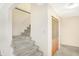 Carpeted stairs in the hallway, with access to rooms via folding doors at 5549 Hollister Dr, Indianapolis, IN 46224