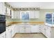 Kitchen featuring updated appliances, tile floor, and white cabinets at 5549 Hollister Dr, Indianapolis, IN 46224