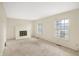 Open living room with a brick fireplace, new carpet, and an abundance of natural light at 5549 Hollister Dr, Indianapolis, IN 46224