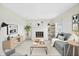 Bright living room features a decorative fireplace, modern furnishings, and beautiful decor throughout the space at 5549 Hollister Dr, Indianapolis, IN 46224