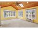 Sun room features a wood-planked ceiling, a ceiling fan and a skylight at 5549 Hollister Dr, Indianapolis, IN 46224