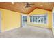 Sun room features a wood-planked ceiling and ceiling fan and a sliding glass door to the outside at 5549 Hollister Dr, Indianapolis, IN 46224