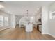 Wide shot of an open-concept living area with kitchen, stairway, and hardwood floors at 555 Gilder Dr, Carmel, IN 46032