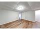 Basement living space with wood-look vinyl floors, new paneled walls, and updated lighting at 6608 Rushing, Noblesville, IN 46062