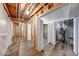 Unfinished basement area featuring wooden framing and laminate flooring, offering potential for customization and added living space at 6608 Rushing, Noblesville, IN 46062