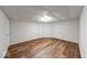 Spacious basement area with wood-look vinyl floors, bright lighting, and white paneled walls at 6608 Rushing, Noblesville, IN 46062