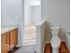View of half bath next to an upstairs bedroom featuring wood flooring and a toilet, offering convenience and style at 6608 Rushing, Noblesville, IN 46062