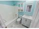 This bathroom features blue walls and a white shower and vanity for a clean and bright look at 6608 Rushing, Noblesville, IN 46062