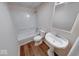 Bright bathroom featuring a tub, toilet, pedestal sink, and modern fixtures, perfect for a comfortable and functional space at 6608 Rushing, Noblesville, IN 46062