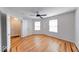 Inviting bedroom featuring stylish hardwood floors, ceiling fan, and large windows at 6608 Rushing, Noblesville, IN 46062