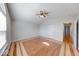 Open bedroom with parquet hardwood flooring, large windows, and a ceiling fan at 6608 Rushing, Noblesville, IN 46062