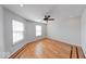 Bright bedroom features parquet hardwood flooring, large windows, and a ceiling fan at 6608 Rushing, Noblesville, IN 46062