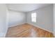 This bedroom offers hardwood floors and a window letting in light for a cozy space at 6608 Rushing, Noblesville, IN 46062