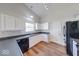 Bright kitchen features white cabinetry, dark countertops, and stainless steel appliances at 6608 Rushing, Noblesville, IN 46062