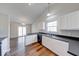 Kitchen with white cabinets, dark countertops and wood-look flooring at 6608 Rushing, Noblesville, IN 46062