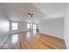 Light-filled living room with gleaming hardwood floors and seamless flow to dining at 6608 Rushing, Noblesville, IN 46062