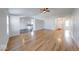 Open-concept living room featuring gleaming hardwood floors and seamless flow into the kitchen at 6608 Rushing, Noblesville, IN 46062