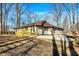 A ranch style home with a stone retaining wall and new wood deck in a partially wooded lot at 6775 W Woodcrest Dr, Greenfield, IN 46140