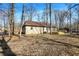 The backyard is a partially wooded lot with a wood deck and a ranch style home at 6775 W Woodcrest Dr, Greenfield, IN 46140
