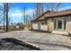 The backyard features a beige brick home with a wood deck and a shed with a rolling door at 6775 W Woodcrest Dr, Greenfield, IN 46140