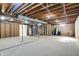 Unfinished basement awaiting your design has utilities, beams, and plumbing exposed at 6775 W Woodcrest Dr, Greenfield, IN 46140
