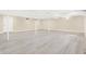 Spacious finished basement with light wood flooring, neutral walls, and recessed lighting offers versatility at 6775 W Woodcrest Dr, Greenfield, IN 46140