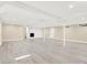 Finished basement with vinyl flooring, bright lighting, and a fireplace at 6775 W Woodcrest Dr, Greenfield, IN 46140