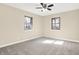 Bedroom with neutral carpet, ceiling fan with lighting, and windows for natural light at 6775 W Woodcrest Dr, Greenfield, IN 46140
