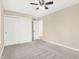 Inviting bedroom with large closet, a ceiling fan, and neutral carpeting for a cozy and serene space at 6775 W Woodcrest Dr, Greenfield, IN 46140