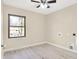 Well-lit bedroom featuring a ceiling fan, wood-look floors, and natural light from a window at 6775 W Woodcrest Dr, Greenfield, IN 46140