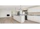 Modern kitchen featuring granite counters, stainless steel appliances, and a large island opens to a sunlit living area with a fireplace at 6775 W Woodcrest Dr, Greenfield, IN 46140
