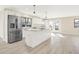 Bright kitchen showcases white cabinets, granite countertops, stainless steel appliances, and a large central island for cooking and entertaining at 6775 W Woodcrest Dr, Greenfield, IN 46140