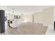 Open-concept living room with hardwood floors, modern lighting, and stainless steel refrigerator, perfect for gatherings and everyday living at 6775 W Woodcrest Dr, Greenfield, IN 46140