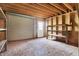 A new shed featuring wood frame construction, a rolling garage door, and shelving at 6775 W Woodcrest Dr, Greenfield, IN 46140