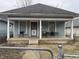 Charming home featuring a cozy front porch for relaxing and entertaining outdoors at 712 Lynn St, Indianapolis, IN 46222