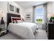 Charming bedroom featuring a bright window, modern decor, and a comfortable bed with accent pillows at 746 Astor Dr, Carmel, IN 46032
