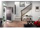 Bright entryway featuring hardwood floors, a staircase, and tasteful decor, creating a welcoming ambiance at 746 Astor Dr, Carmel, IN 46032