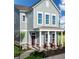 Charming two-story home featuring a covered porch with stone accents and a well-manicured front yard at 746 Astor Dr, Carmel, IN 46032