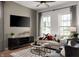 Cozy living room featuring a comfortable sofa, stylish rug, and modern entertainment center with TV at 746 Astor Dr, Carmel, IN 46032