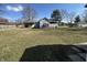 Spacious backyard with a well-maintained lawn, mature trees, and partial fencing, perfect for outdoor activities at 7610 Brehob Rd, Indianapolis, IN 46217