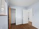 This cozy bedroom features wood-look floors, neutral walls, and a closet for ample storage at 7610 Brehob Rd, Indianapolis, IN 46217
