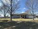 Cozy single-story home boasting a covered front porch, attached garage, and a well-maintained lawn at 7610 Brehob Rd, Indianapolis, IN 46217