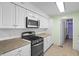 Well-equipped kitchen with a gas range, microwave, and white cabinets for plenty of storage at 7610 Brehob Rd, Indianapolis, IN 46217
