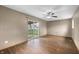 Open living room with sliding glass doors leading to the backyard and hardwood floors at 7610 Brehob Rd, Indianapolis, IN 46217