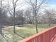 Backyard view from a deck with a trampoline and green space surrounded by trees at 7811 W 700 S, Jamestown, IN 46147