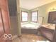 Bathroom featuring a corner tub, vanity, and natural light from two windows at 7811 W 700 S, Jamestown, IN 46147