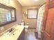Bathroom with a large mirror, shower, toilet, and vanity with a sink at 7811 W 700 S, Jamestown, IN 46147