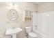 Well-lit bathroom featuring a pedestal sink, updated fixtures, and a bathtub with shower at 8535 Fenton Tower Dr, Indianapolis, IN 46259