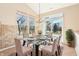 Sunlit dining area features a modern chandelier and a sliding door to the backyard at 8535 Fenton Tower Dr, Indianapolis, IN 46259